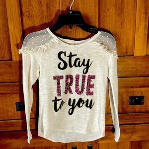 A long sleeved white shirt that says stay true to you size 7/8